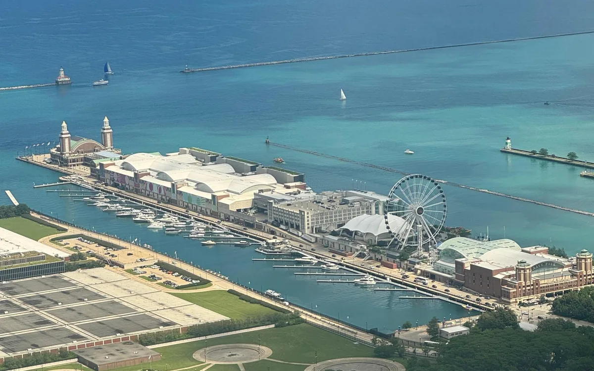 Navy Pier and its Ferris wheel from above, with Lake Michigan beyond