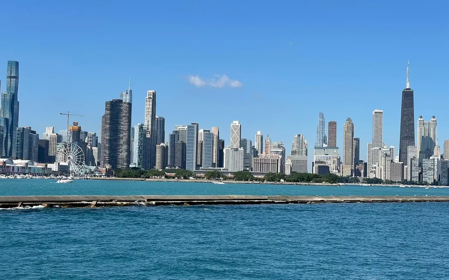 The Chicago skyline across blue water under a clear sky