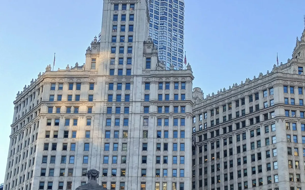 White terracotta towers seen from street level against a blue sky